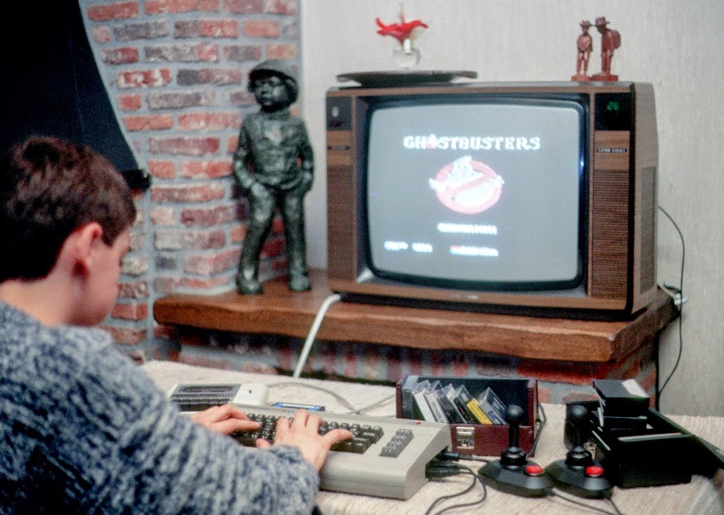 A young Peter van Dijck playing Ghostbusters on a Commodore 64